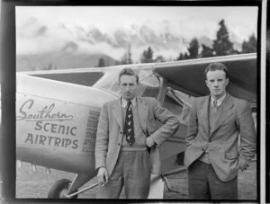Mr C B Topliss, engineer, and Mr C W Hewitt (right), working on the engine of a Southern Scenic Airtrips Ltd aeroplane, [Queenstown?]