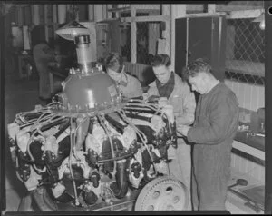 Messrs C Taylor, R J Elson and L E Crossan working on an aircraft engine, Harewood, Christchurch