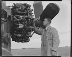 National Airways Corporation, Mr L N Howland (Senior Engine Inspector) standing by aircraft portable engine test stand, Harewood, Christchurch