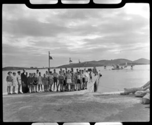 School group standing on the wharf, La Flotille, Noumea, New Caledonia, a Qantas Catalina flying boat in the background