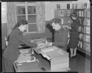 In the library, from left are J E Verner, Flight Sergeant D Fagan, J A M Gillespie, Royal New Zealand Air Force