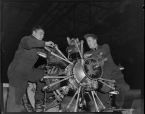 Fitters D Turner and L Laing working on an aircraft engine, Wigram, Christchurch