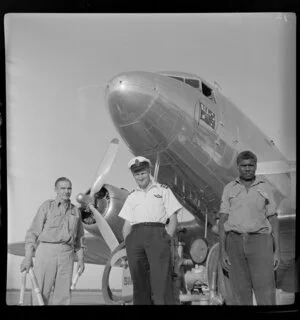 Qantas Inland Service, Daly Waters, Northern Territory, Australia, from left are T Humphries, Qantas agent, Captain N A Lewis, [Jackie?] Aboriginal petrol attendant