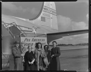 Miss Shirley Fyfe and an unidentified group, having arrived on Pan American World Airways Douglas DC-4 NC88951 Clipper Racer aircraft [Whenuapai Royal New Zealand Air Force base?]