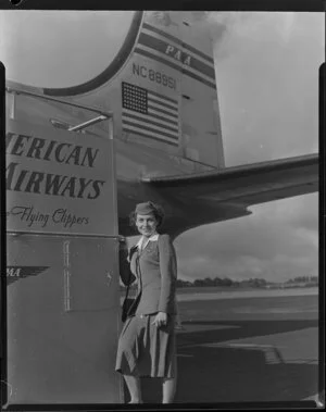 Pan American World Airways stewardess Margaret Grana in front of Douglas DC-4 NC88951 Clipper Racer [Whenuapai Royal New Zealand Air Force base?]