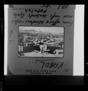 Copy of a photographic slide showing the view from an office window in Kabul over mud roofs towards Qala-e-Fatullah, Afghanistan