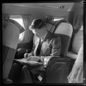 An unidentified male passenger works on a National Airways Corporation Douglas DC-3 flight from Auckland to Suva