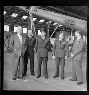 P T Cook, N A Adler (right - Brown and Durea Technical Manager, aviation division), B Ainsworth (left - United Aircraft) and Royal Australian Airforce officers (RAAF) in front of a helicopter in Melbourne, Australia