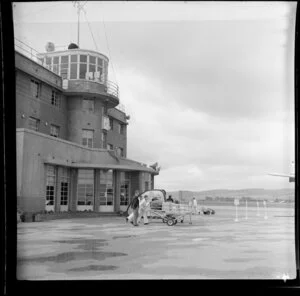 Part two of a two part panorama, airport crew wheeling luggage to the aeroplane, Parafield airport, Adelaide