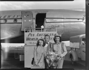 Stan Korman and [family?] in front of Pan American World Airways Clipper Mandarin aeroplane