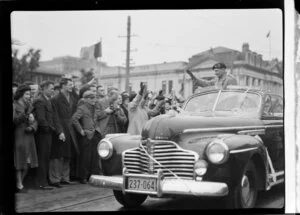 Viscount Bernard Law Montgomery in car waving at onlookers in street parade, Wellington
