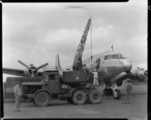 Coles Crane and Scott Ramsay watching freight being loaded onto Warana aircraft, Pan American World Airways