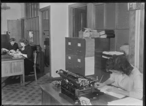 Unidentified office interior with female staff workers and typewriter