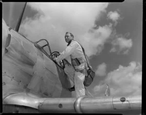 S/L [Squadron Leader?] Keith Patterson, Officer Commanding, Territorial Air Force, with an Harvard aeroplane, [Whenuapai, Auckland?]