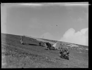 Auckland gliding club members pushing the glider up a hill