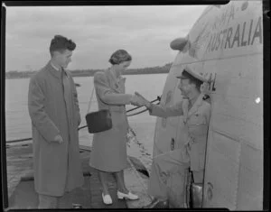 Captain Griffiths of Tasman Empire Airways Ltd greeting British Overseas Airways Corporation essay winners Susan McClean and Brian Woods as they board the seaplane on their trip to Australia