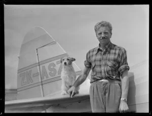 Mr Vic Hunter of Rotorua with dog beside his Fairchild Argus aircraft, [Tauranga Aero Club?]