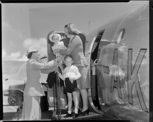 Mrs Gould, Paraparaumu airport hostess, helping passengers off the aircraft