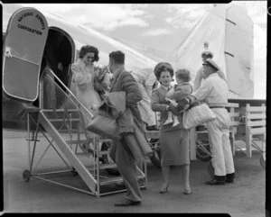Miss Penner, Christchurch airport hostess, helping passengers off the aircraft