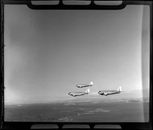 RNZAF (Royal New Zealand Air Force) Squadron 41, flying DC4 airplanes over Rangitoto, Auckland