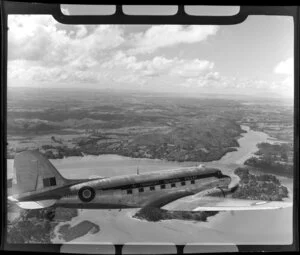 RNZAF (Royal New Zealand Air Force), 41 Squadron, Dakota in flight over the west coast, Auckland