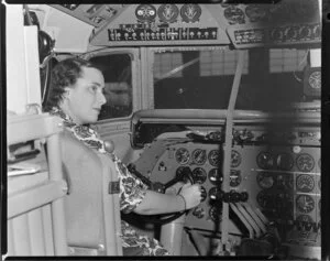 Miss Gwen Robyns at the controls of a DC6 RMA Adventurer, British Commonwealth Pacific Airlines