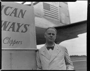 Ace Williams, photographer, standing alongside a Pan American World Airlines Clipper aircraft