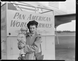 Nuella Van Horn holding child, Fred Van Horn, at Pan American World Airways Flying Clipper