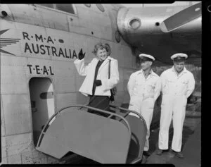 Miss New Zealand, Mary Woodward boarding Tasman Empire Airways Ltd aircraft, RMA Australia with unidentified men standing alongside her