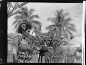 Unidentified young Fijian woman with a bowl of flowers