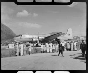A crowd observes a Qantas Empire Airways Douglas DC-4 (VH-EBK) aircraft, Kowloon, Hong Kong