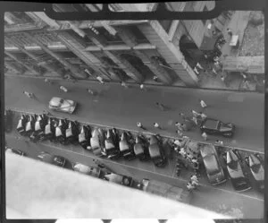 Looking down on to the street with a row of cars parked in the centre, Hong Kong