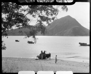 Fishermen sorting out their nets on a sandy beach, Hong Kong