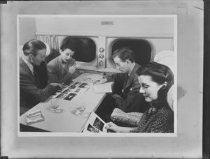 Four passengers seated in an unidentified aircraft