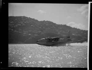 Tasman Empire Airways Limited Short S.45 Solent flying boat, R.M.A Araragi (ZK-AMM), landing at Evans Bay, Wellington, with the suburb of Roseneath in the background