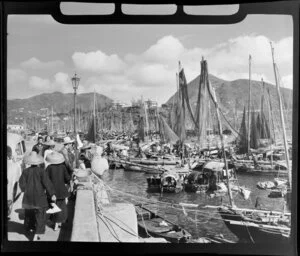 Waterfront street scene, Hong Kong, including moored boats and pedestrians