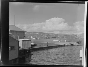 Flying boat base near Hataitai beach, Wellington, with the Tasman Empire Airways Limited Short S.45 Solent flying boat, R.M.A Araragi (ZK-AMM), moored in Evans Bay in the background