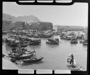 Coastal scene, Hong Kong, featuring a village of small houseboats and including the buildings of Imperial Chemical Industries China Limited