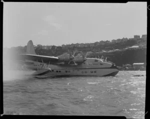 A Tasman Empire Airways Limited Short S.45 Solent flying boat, R.M.A Ararangi (ZK-AMM), moored in Evans Bay, Wellington, with Hataitai in the background