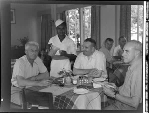 Unidentified men and waiter in the dining room of the Northern Hotels, Fiji
