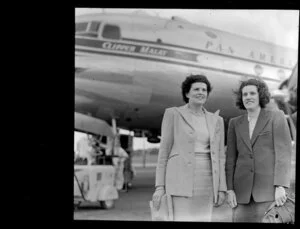 Mrs V Benjamin and Pamela, standing alongside the Pan American World Airways Clipper Malay