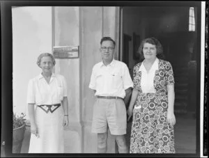 Unidentified man and two women outside the front doors of Northern Hotels, Fiji