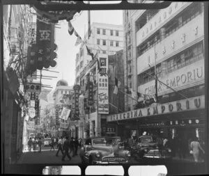 Busy street scene (Queens Road), Hong Kong, including businesses such as China Emporium and Tung Hing Company Tailors