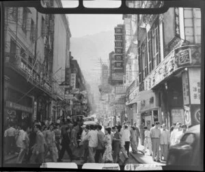 Busy street scene, Hong Kong, including businesses such as Kwong On Ivory Factory and Tajmahal Silk Store Ltd