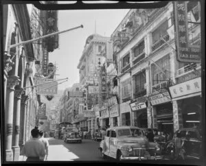 Busy street scene, Queens Road, Hong Kong, including businesses such as Kam Moon Cafe, A Assomull & Co (exporters and importers) and Hsu Brothers (Silk Lingeries and Art Linens)