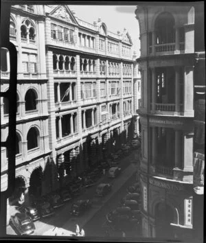 Elevated view of the Alexandra Building, Hong Kong, with apartment buildings and parked cars below