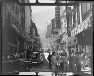 Busy street scene (Queens Road), Hong Kong, including businesses such as Kwong On Ivory Factory and Tajmahal Silk Store Ltd