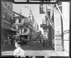 Busy street scene (Queens Road), Hong Kong, including a sign reading San Minguel Beer and businesses such as Cafe de China, Ivy's Restaurant, Bata Shoes, Sun Yung Ming Studio