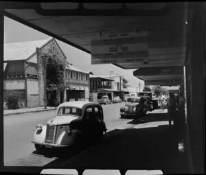 Street scene, Darwin, Northern Territory, Australia, featuring parked Rolls Royce, Koolpinyah Kool Stores (Butchers Ice & Cold Storage), Hotel Victoria, and Royal Mail agent and coach booking office