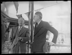 Two unidentified men talking [at a Tasman Empire Airways Ltd event]
